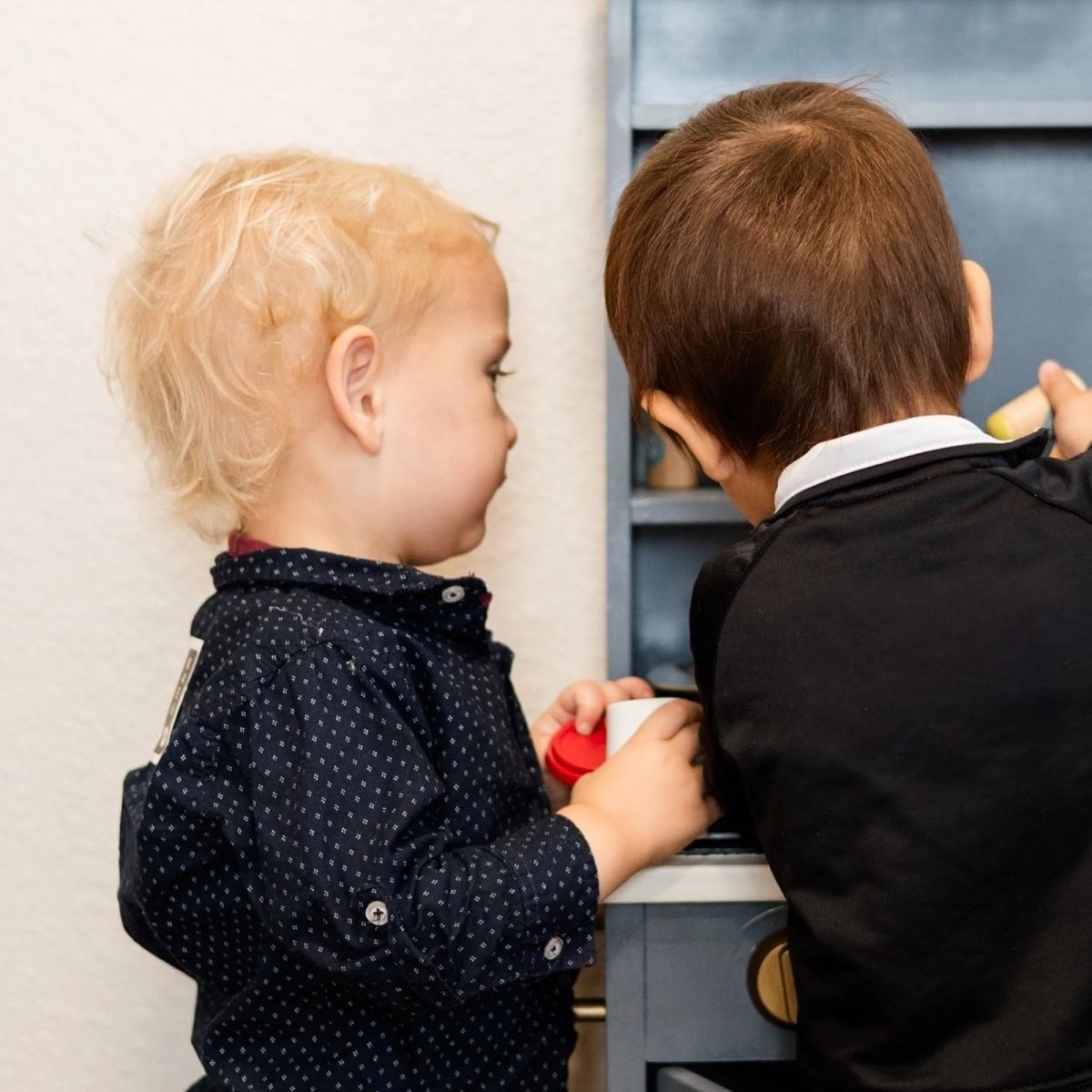 Two toddlers playing together in the infant room