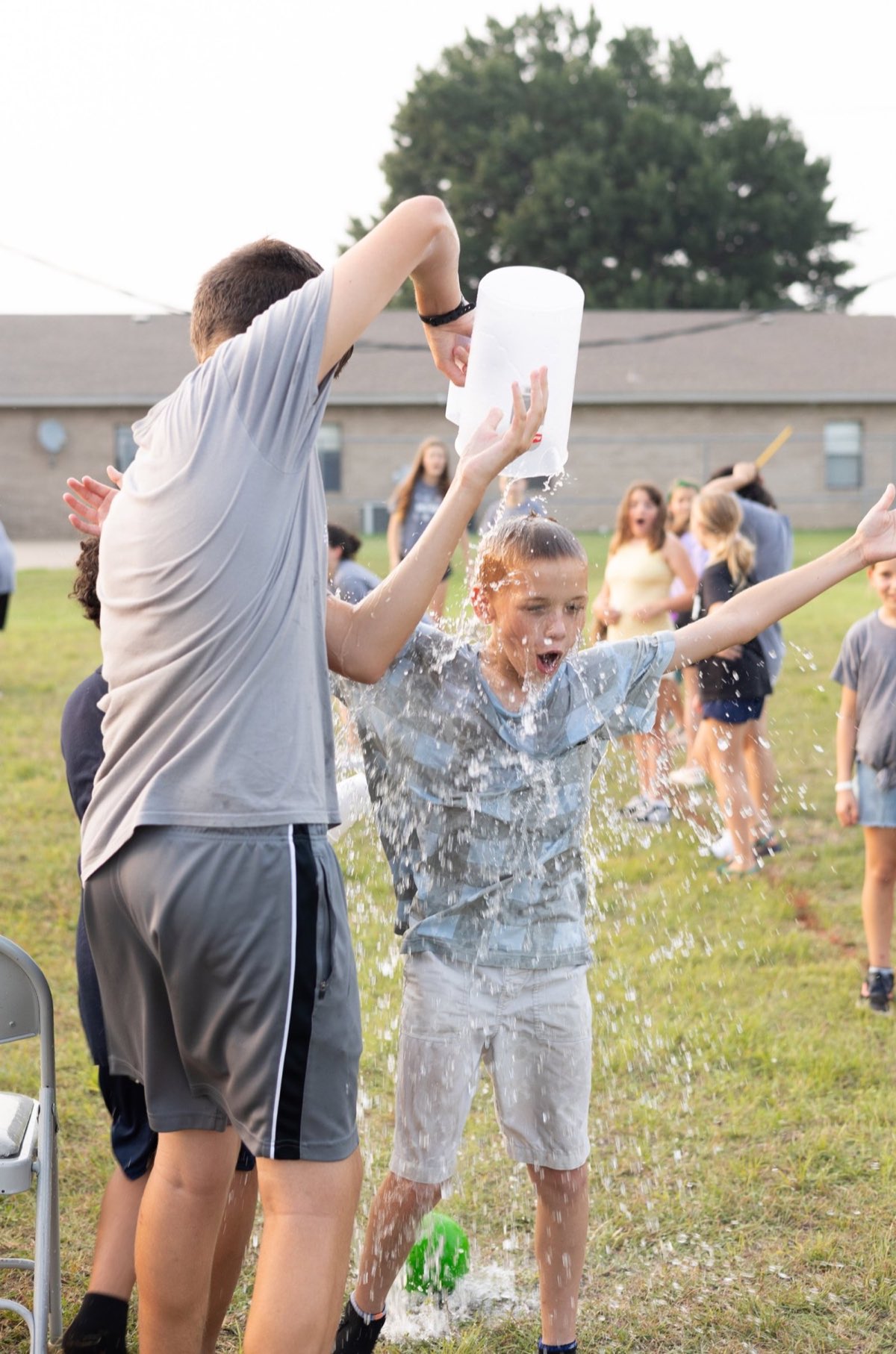 A child being splashed with water at VBS Rec Week